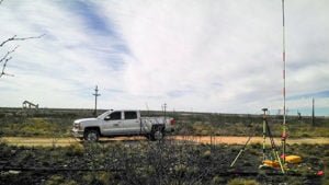 RRC work pickup truck parked next to survey equipment in field